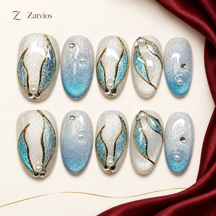 Zatvios Ocean Laurel DM-558 — ten-nail design display; Ice blue / Pale shimmer / Gold / Pearl-looking accents
